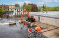 Dredger clearing debris from water intake to hydro electric generator in Almonte, Ontario, Canada