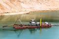 Dredger on a sandy quarry with a raised soil intake device