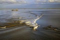 Dredger vessel in the distance in the Wadden Sea preventing the fairway from silting up, Holland