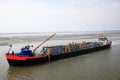 Dredger vessel in the Wadden Sea preventing the fairway from silting up