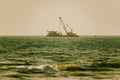 Dredger working at sea. Ship excavating material from a water environment