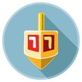 Dreidel with Hebrew letters spinning in a blue circle with a long shadow Royalty Free Stock Photo