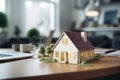 Drendered Model Of Compact Home Displayed On Table At Real Estate Agency