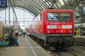 Red electric locomotive with a passenger train close-up. Dresden Railway Station