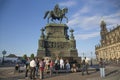 A group of tourists near the Monument of King Johann of Saxony on Theater Square in Dresden