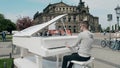 DRESDEN, GERMANY - MAY 2, 2018. Pianist playing grand piano in the centre of the city Royalty Free Stock Photo