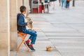 Street musician kid performing music for donating money and coins Royalty Free Stock Photo