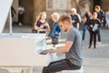 Street musician piano player performing music for donating money and coins Royalty Free Stock Photo