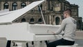 DRESDEN, GERMANY - MAY 2, 2018. Young man playing grand piano in historic centre of the city Royalty Free Stock Photo