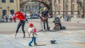 Dresden, Saxony, Germany - June 1, 2022: Guitar street musician and beautiful street dancer as a young girl in historical center