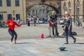 Dresden, Saxony, Germany - June 1, 2022: Guitar street musician and beautiful street dancer as a young girl in historical center