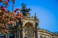 Dresden Semper Opera theatre Semperoper, front view in spring. Blooming branches on foreground. Royalty Free Stock Photo