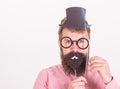 Dress affects how people see you. Man bearded hipster hold cardboard top hat and eyeglasses to look smarter white