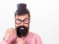 Dress affects how people see you. Man bearded hipster hold cardboard top hat and eyeglasses to look smarter white