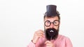 Dress affects how people see you. Man bearded hipster hold cardboard top hat and eyeglasses to look smarter white