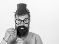 Dress affects how people see you. Man bearded hipster hold cardboard top hat and eyeglasses to look smarter white