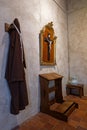 Dress and cross in a Monk cell in Brou monastery