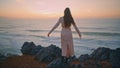 Dress lady watching evening marine nature back view. Woman touching hairstyle Royalty Free Stock Photo