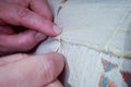 Dress maker working. Woman hadn sewing clothes. Closeup sewing.