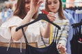 This dress is perfect Rear view of beautiful young woman trying on dress and looking at her reflection in the mirror Royalty Free Stock Photo