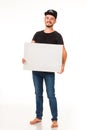 A guy with a beard posing with a white sign. Can be used for advertising, logo and business cards, contact phones, shares, etc.