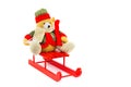 Dressed Christmas bear on red wooden sleigh