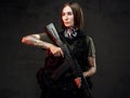 Armed with rifle attractive woman in dark background Royalty Free Stock Photo