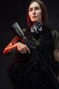 Armed with rifle attractive woman in dark background Royalty Free Stock Photo