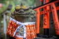 Dressed god statue and tori gates, Fushimi Inari Shrine, Kyoto Royalty Free Stock Photo