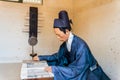 Dressed mannequin of an eunuch reading books at Hwaseong Haenggung Palace, the ornate residential palace built for King Jeongjo wh