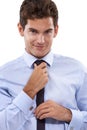 Dressed for success. A handsome young businessman adjusting his tie. Royalty Free Stock Photo