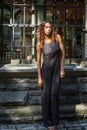 Young woman standing outdoors by window in New York City, looking forward Royalty Free Stock Photo