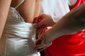 Dressing bride for wedding ceremony