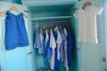 Dressing closet with blue clothes in the closet