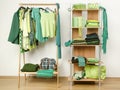 Dressing closet with green clothes arranged on hangers and shelf.