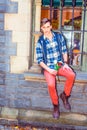 A young guy is sitting by a window, holding a white flower, waiting for you Royalty Free Stock Photo