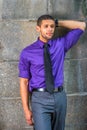 Young man standing outdoors by wall in New York City, relaxing, thinking Royalty Free Stock Photo