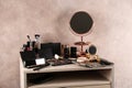 Dressing table with beauty accessories near color wall Royalty Free Stock Photo