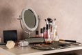 Dressing table with beauty accessories near color wall Royalty Free Stock Photo