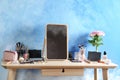 Dressing table with beauty accessories near color wall Royalty Free Stock Photo