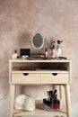 Dressing table with beauty accessories near color wall Royalty Free Stock Photo