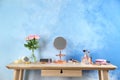 Dressing table with beauty accessories in room Royalty Free Stock Photo