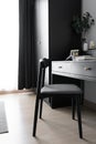 Dressing table corner with black wood power table and black wooden chair  and circular black mirror in natural light scene / cozy Royalty Free Stock Photo