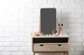 Dressing table with different makeup products and accessories in room interior Royalty Free Stock Photo