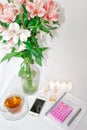 Dressing table with women`s accessories. Image of a pink gift box with a bouquet of Alstroemeria flowers, romantic candles, perfum Royalty Free Stock Photo