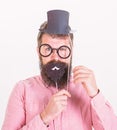 Dressing well makes you seem more intelligent. Man bearded hipster cardboard top hat and eyeglasses to look smarter