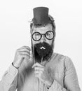 Dressing well makes you seem more intelligent. Man bearded hipster cardboard top hat and eyeglasses to look smarter
