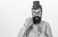 Dressing well makes you seem more intelligent. Tricks to seem more intelligent. Man bearded hipster cardboard top hat