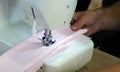 The dressmaker elaborately made thread pattern on a fine pink fabric