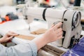 Dressmaker hands sews fabrics on a sewing machine